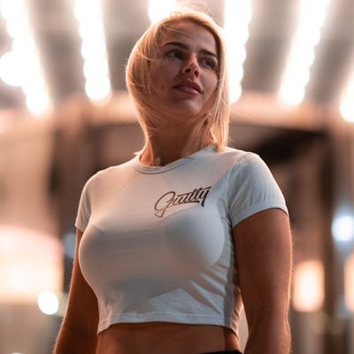 Guilty Crop Tee White - Women's white crop tee by Guilty Apparel featuring GA logo, perfect for action sports and adventure