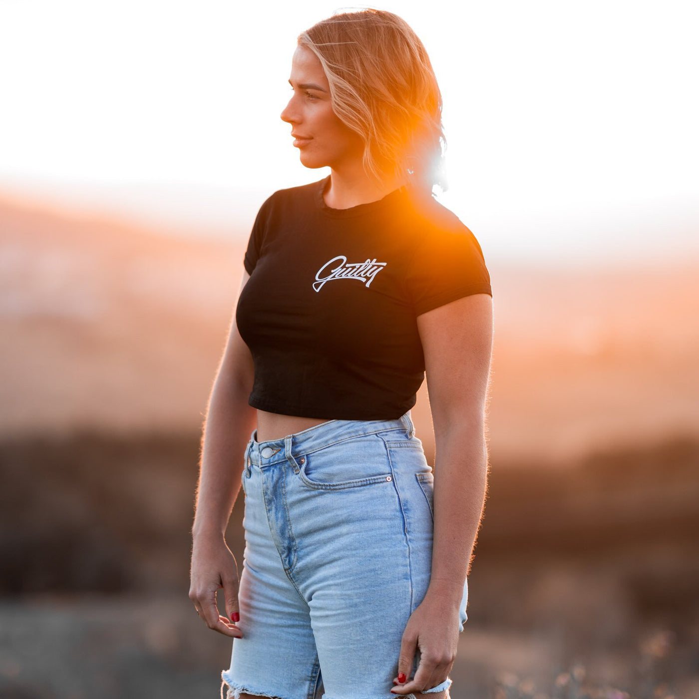 Guilty Crop Tee Black - Women's black crop tee by Guilty Apparel, perfect for action sports and adventure