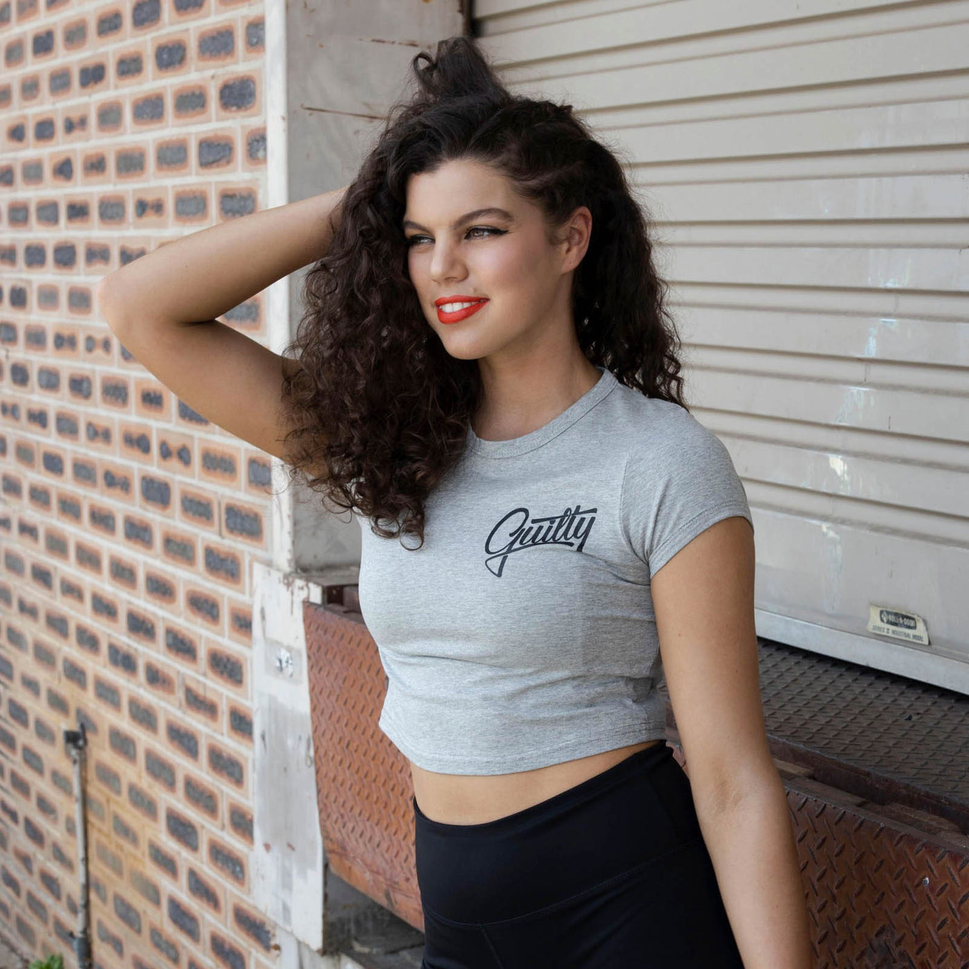 Guilty Apparel Crop Tee Grey - Casual and comfortable grey crop top with a black Guilty Apparel logo printed on it.