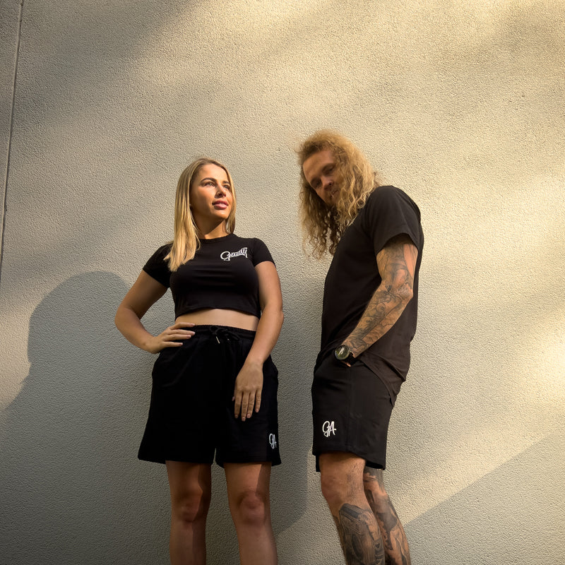 Unisex GA Shorts - Black athletic shorts by Guilty Apparel featuring GA logo, perfect for action sports and adventure