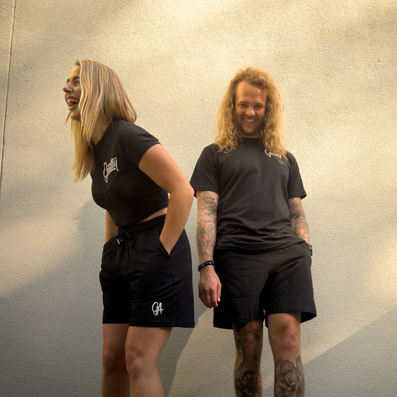 Unisex GA Shorts - Black athletic shorts by Guilty Apparel featuring GA logo, perfect for action sports and adventure